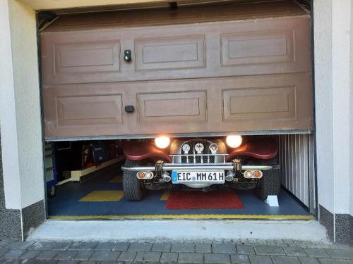a garage with a car parked under a garage door at Home&Classic - Alte Werkstatt in Effelder