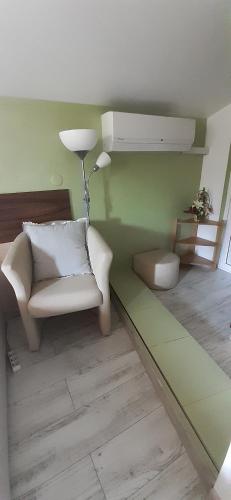 a living room with a chair and a lamp at Guesthouse Geto in Belogradchik