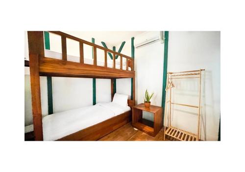 a bedroom with two bunk beds and a table at Cabana Surf and Stay in Biha
