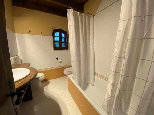 a bathroom with a shower curtain and a sink at Vivienda Vacacional La Vara VV-1433-AS in Arriondas