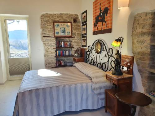 a bedroom with a bed and a stone wall at Villa Alta Langa in Cravanzana