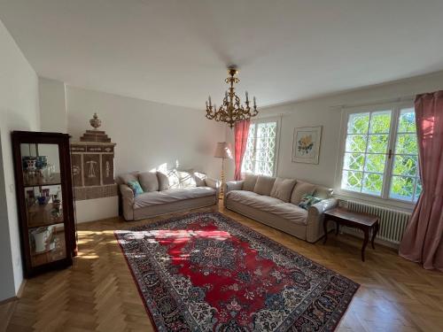 a living room with a couch and a rug at Landvilla im Park 