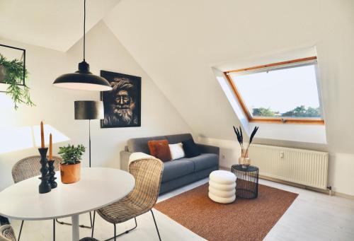 a living room with a couch and a table at GALLERY APARTMENT: MAISONETTE + FREE PARKING + NETFLIX in Essen