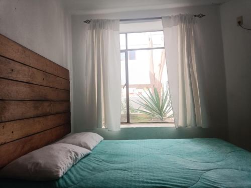 a bedroom with a bed and a window at El Arrayan in Valle de Bravo