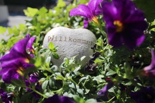 a stone heart in a garden of flowers at Apartment ZIRMWEBER-Haus in Sankt Johann im Pongau