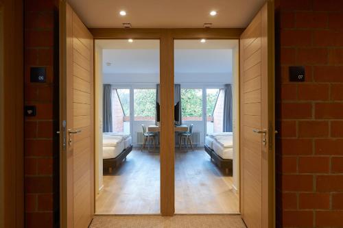 a room with sliding doors and a room with a table at Parkhotel Wallberg in Volketswil