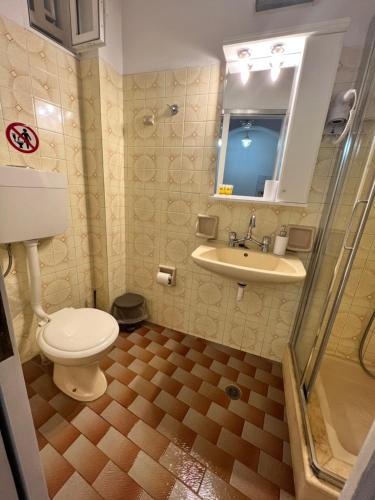 a bathroom with a toilet and a sink at ERIDA Accommodation in Lákka