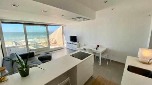 a white office with a view of the ocean at Seanest - North Sea Stays in De Haan