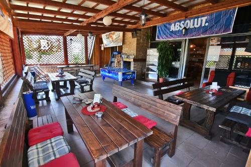 an overhead view of a restaurant with wooden tables and benches at Penzión Šírava in Kaluža