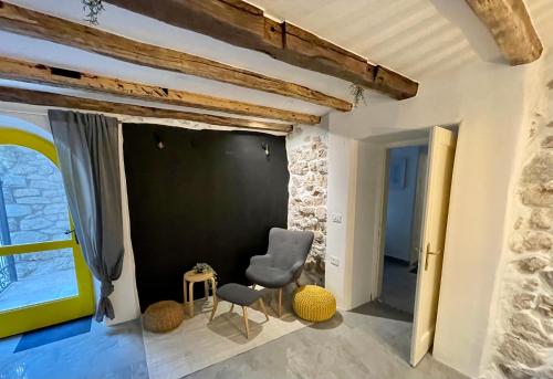 a room with a blackboard and a chair and a table at Bell Tower House in Novi Vinodolski