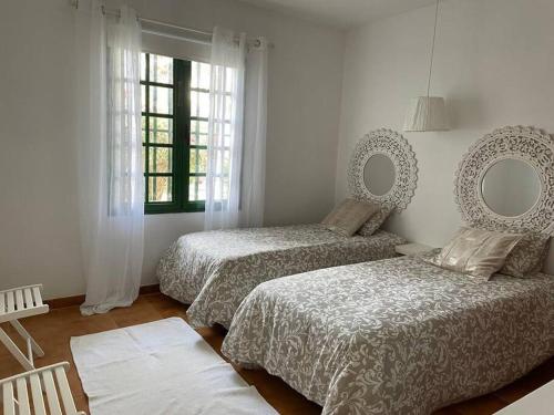 Postel nebo postele na pokoji v ubytování Apartamento Amura en Playa de Las Cucharas