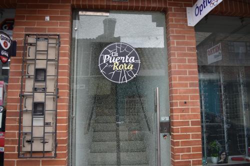 a store front door with a sign on it at La Puerta Rota in Zipaquirá
