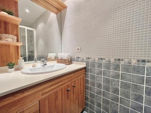 a bathroom with a sink and a mirror at Apartamento Arao Malpica con vistas al mar in Malpica