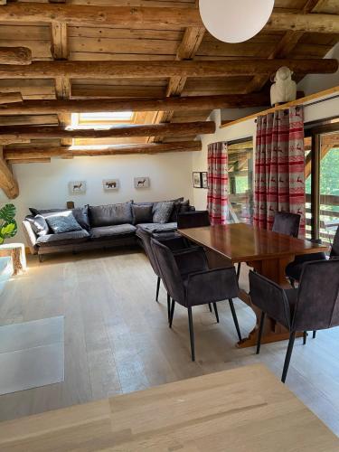 a living room with a table and a couch at Chalet Heron in Les Houches