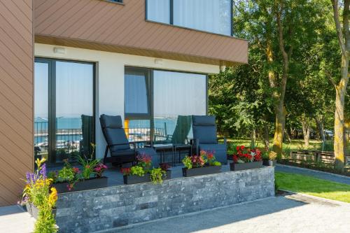 a patio with chairs and flowers on a house at Kraimorie Park in Burgas