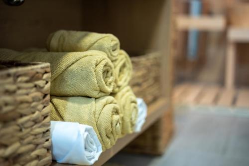 a pile of towels sitting on a shelf in a room at HILLHOME apartment & Sauna in Donovaly