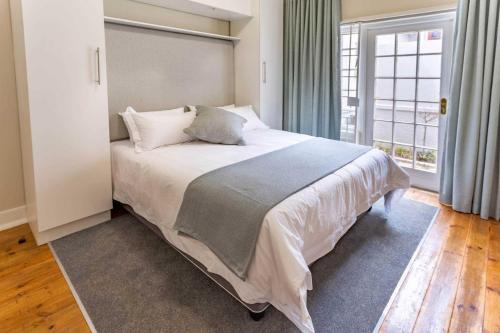 a bedroom with a large bed and a window at Middelberg Manor in Pretoria