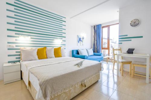 a bedroom with a bed and a desk in it at Modern Studios - Meters away from the beach in Pomorie