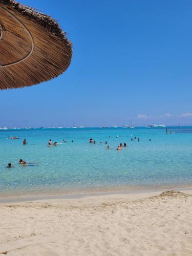a group of people in the water at the beach at Villa La Pelosa Stintino in Stintino