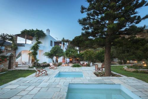 Agios RomanosにあるRomano garden house - land talesの木とスイミングプールのあるパティオ
