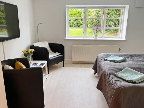 a living room with two beds and a window at Stay Bai-Jensen in Aabenraa