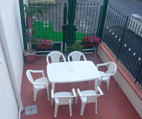 a white table and chairs on a balcony at Astra House relax a 10minuti da Salerno centro in Pellezzano