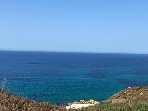 a view of the ocean from a hill at Ta’ Giljan B&B Gozo in Xagħra