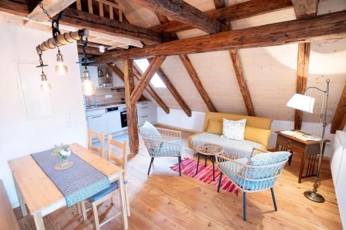 a living room with a couch and chairs and a table at Gästehaus Großhöchberg in Spiegelberg