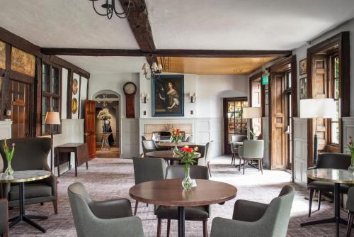 a living room with tables and chairs at Bush Hotel Farnham in Farnham