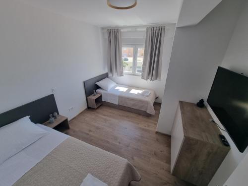 a small room with two beds and a window at Villa Madison in Posedarje