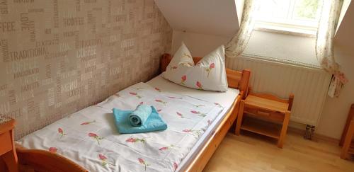 a small bed with a pillow on it in a room at Villa Hoffnung in Bad Elster
