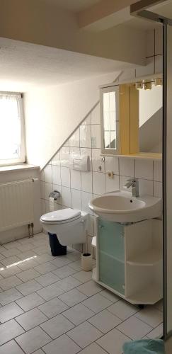 a bathroom with a sink and a toilet at Villa Hoffnung in Bad Elster