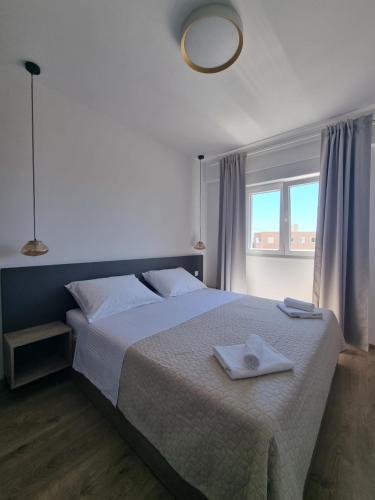 a bedroom with a bed with a towel on it at Villa Madison in Posedarje