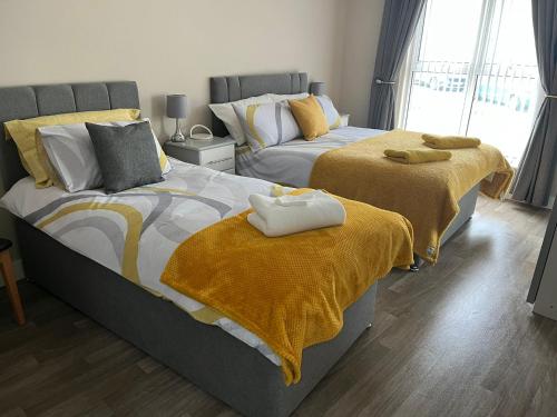 two beds sitting next to each other in a bedroom at Atlantic Port Retreat in Portstewart