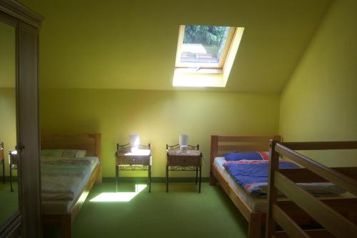 a small room with two beds and a window at Bystre 35 in Bystre