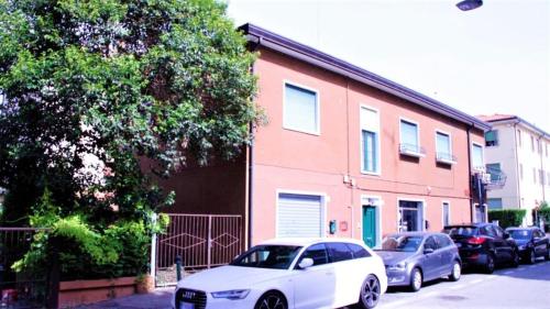 a white car parked in front of a building at Venice Suites in Mestre