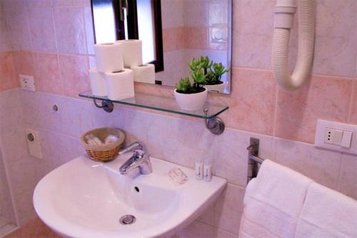 a bathroom with a sink and a mirror at Venice Suites in Mestre