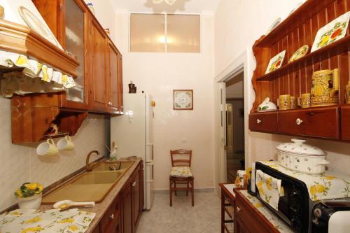 a kitchen with a sink and a refrigerator at B&B CASA PUPETTA in Torre del Greco