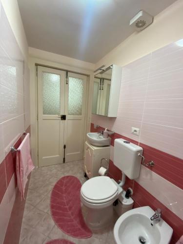 a bathroom with a white toilet and a sink at B&B CASA PUPETTA in Torre del Greco