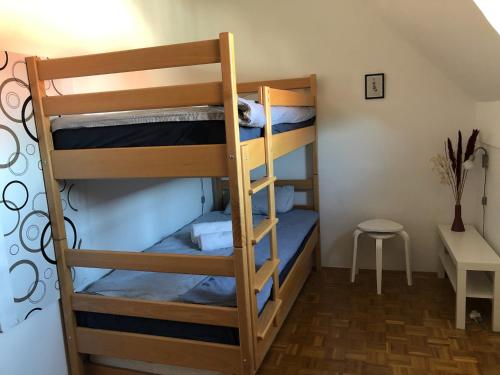 two bunk beds in a room with a table and a stool at Spa House Lotus in Terme Čatež in Čatež ob Savi