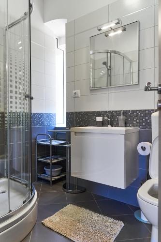 a bathroom with a sink and a toilet and a mirror at Apartments Nives in Cres