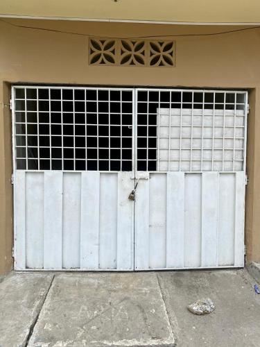 a garage door with a gate in a building at Departamento familiar & empresarial in Machala