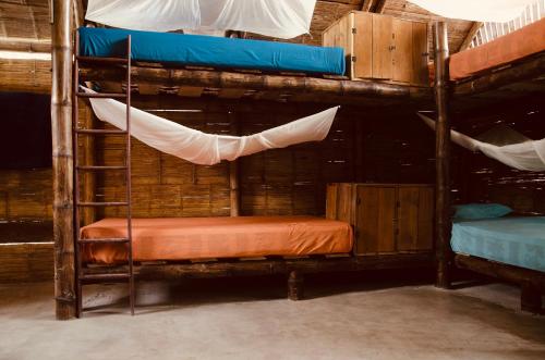 a couple of bunk beds in a room at The Mudhouse Hostel Mompiche in Mompiche