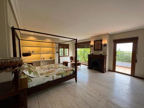 a bedroom with a canopy bed and a fireplace at Villa Ca Toni in Alicante