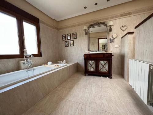 a large bathroom with a tub and a sink at Villa Ca Toni in Alicante