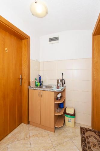 a small kitchen with a sink and a counter at Bogdanoski Studios & Guest Rooms in Ohrid