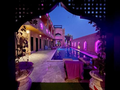 a view of a swimming pool at night at Casa d'Or Dahab PALAZZO in Dahab