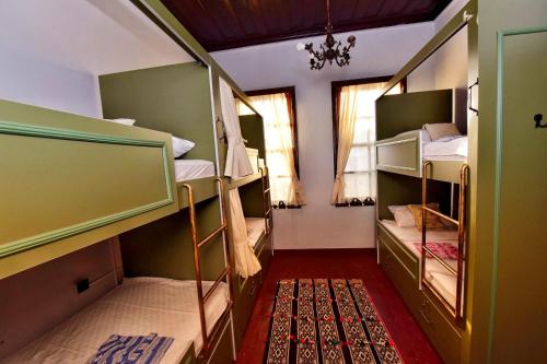 a room with three bunk beds and a window at LORDS HOSTEL & PUB in Antalya
