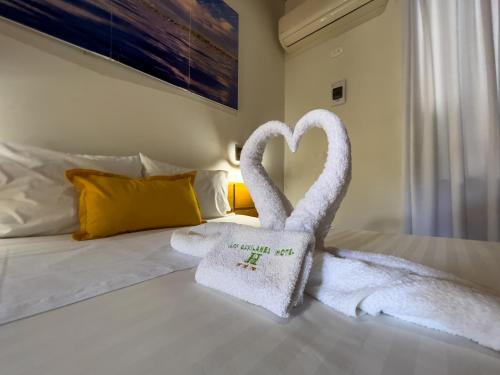 a hotel room with towels in the shape of swans on a bed at Los Gavilanes Hotel in Pucallpa