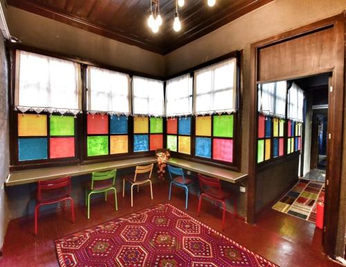 a room with stained glass windows and a table and chairs at LORDS HOSTEL & PUB in Antalya